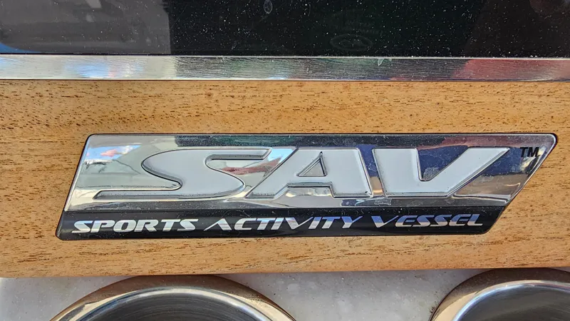 Slide: The Image of 2021 Regal 38 SAV Sports Activity Vessel emblem on wooden panel. - 21