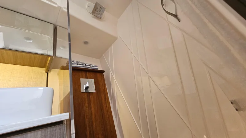 Slide: The Image of Interior of 2021 Regal 38 SAV boat, featuring modern bathroom design. - 30