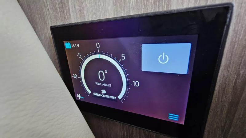 Slide: The Image of Seakeeper control panel on 2021 Regal 38 SAV boat, displaying roll angle and power button. - 32