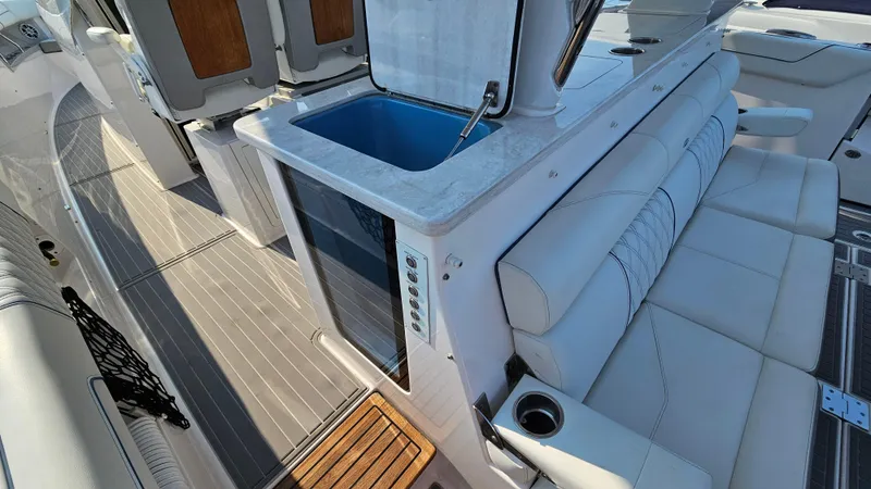 Slide: The Image of 2021 Regal 38 SAV boat interior with seating and kitchenette area. - 33