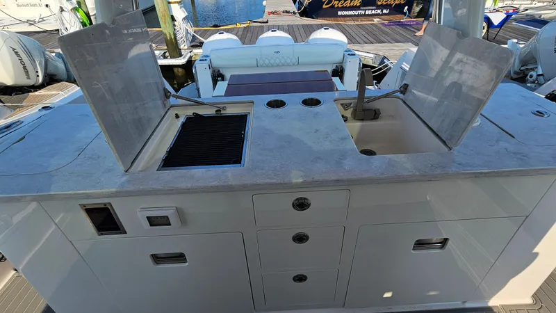Slide: The Image of 2021 Regal 38 SAV boat kitchen area with sink and grill. - 34