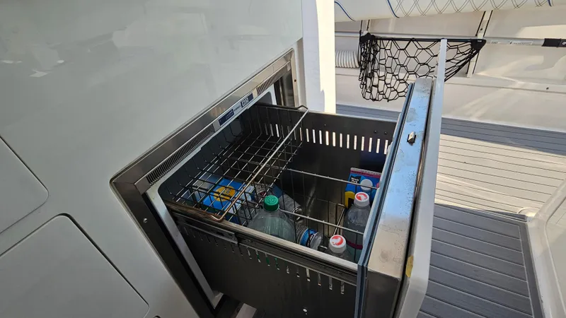 Slide: The Image of Built-in cooler on 2021 Regal 38 SAV yacht, stocked with beverages and snacks. - 36