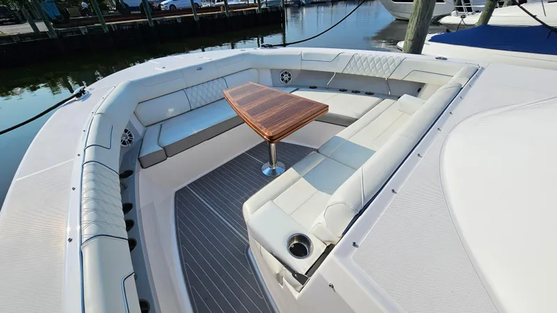 Slide: The Image of Luxurious seating area on 2021 Regal 38 SAV boat with elegant wooden table. - 4