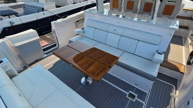 Slide: The Image of 2021 Regal 38 SAV yacht interior with elegant seating and wooden table. - 41