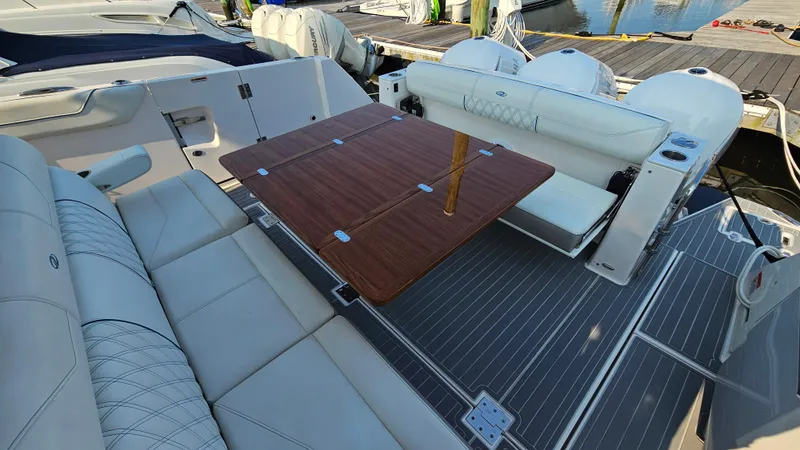 Slide: The Image of 2021 Regal 38 SAV boat interior with elegant seating and wooden table. - 42