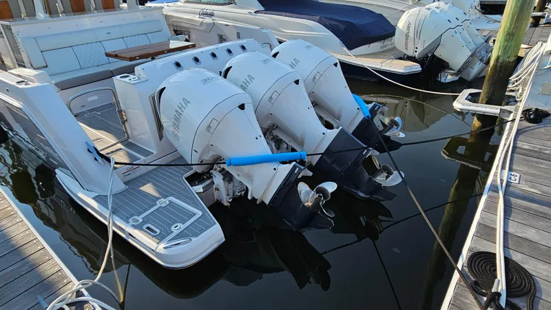Slide: The Image of 2021 Regal 38 SAV with triple Yamaha outboard engines docked at marina. - 49