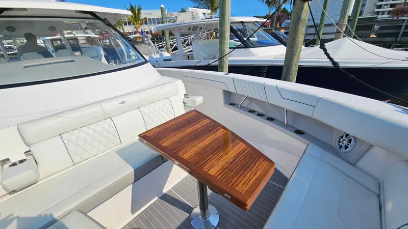 Slide: The Image of 2021 Regal 38 SAV yacht interior with elegant seating and wooden table. - 5