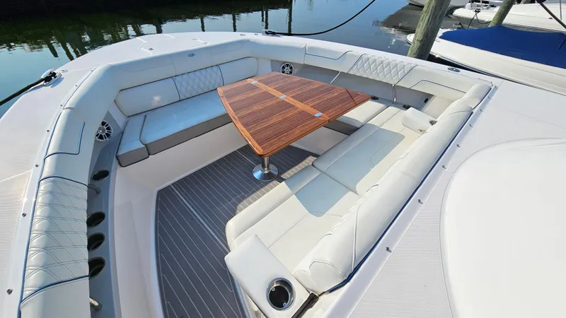 Slide: The Image of Luxurious seating area on 2021 Regal 38 SAV boat with wooden table. - 6