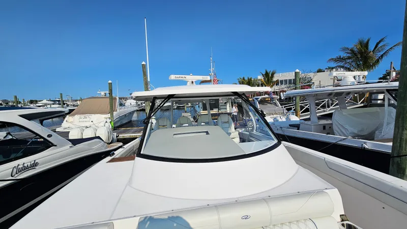 Slide: The Image of 2021 Regal 38 SAV boat docked at marina under clear blue sky. - 7