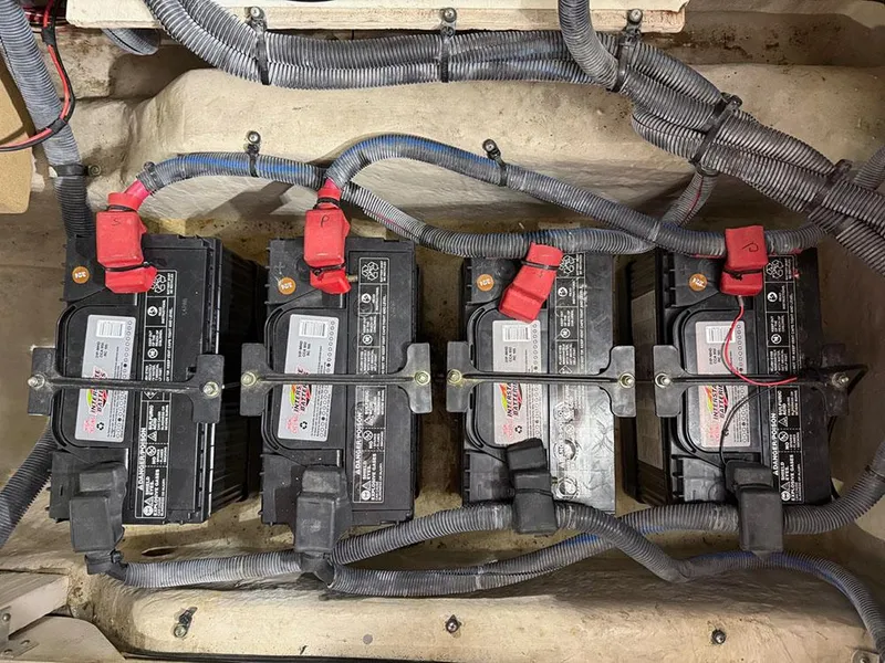 Slide: The Image of Four marine batteries in a 2003 Sea Ray 390 Motor Yacht engine compartment. - 14