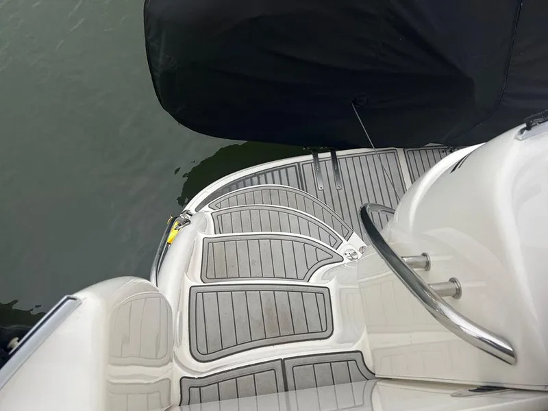 Slide: The Image of 2003 Sea Ray 390 Motor Yacht swim platform with gray decking, docked by water. - 27