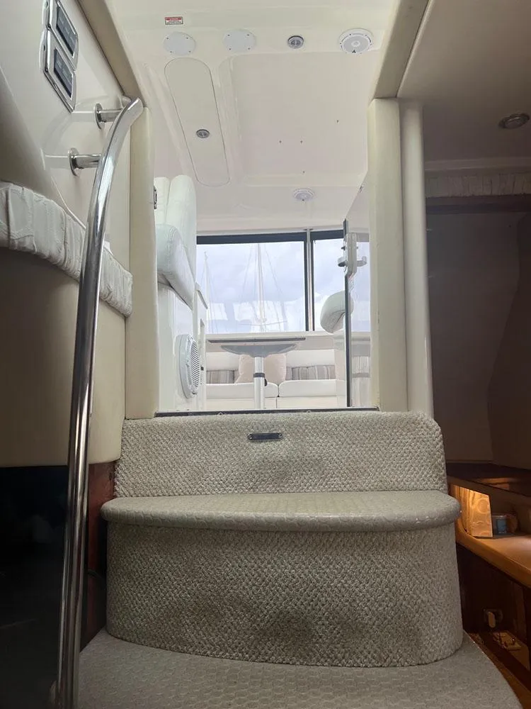 Slide: The Image of Interior view of 2003 Sea Ray 390 Motor Yacht, featuring carpeted steps and modern design. - 28