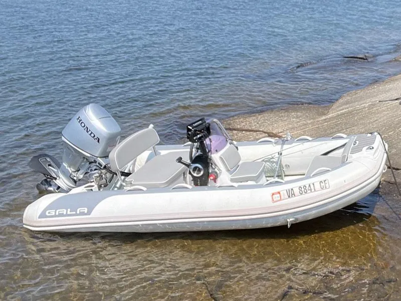 Slide: The Image of A small inflatable boat with a Honda motor, docked on a rocky shoreline. - 3