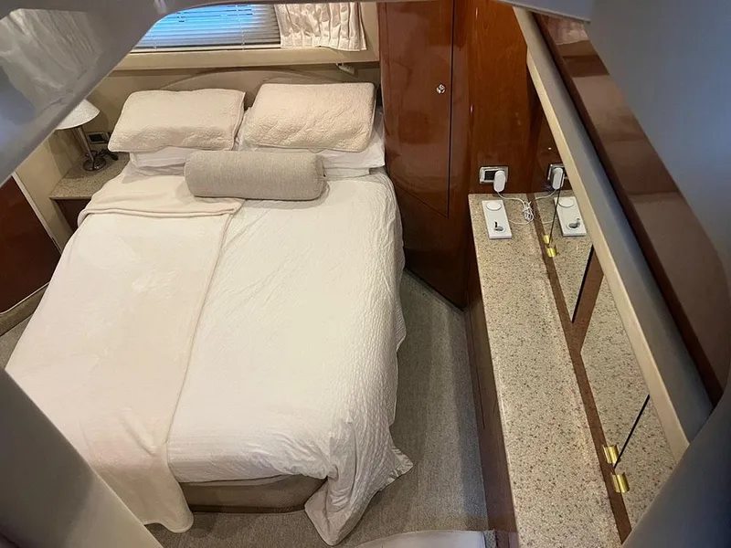 Slide: The Image of Luxurious bedroom interior of 2003 Sea Ray 390 Motor Yacht with cozy bedding and elegant decor. - 30
