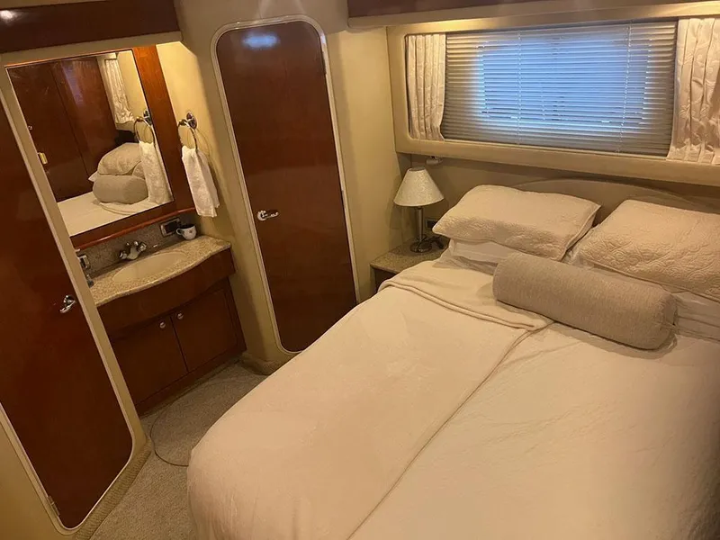 Slide: The Image of Luxurious bedroom interior of 2003 Sea Ray 390 Motor Yacht with cozy bed and elegant decor. - 31