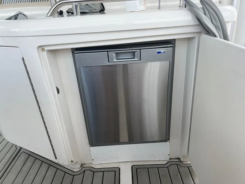 Slide: The Image of Stainless steel dishwasher on 2003 Sea Ray 390 Motor Yacht, integrated into white cabinetry. - 37