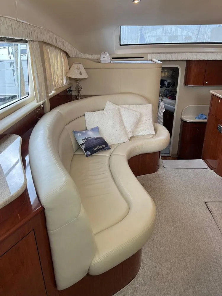 Slide: The Image of 2003 Sea Ray 390 Motor Yacht interior with curved leather seating and elegant decor. - 40