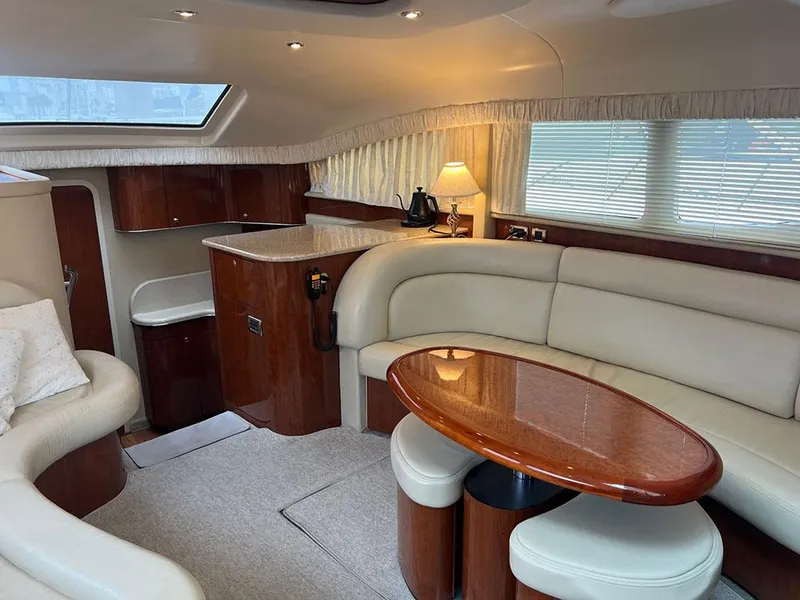 Slide: The Image of Luxurious interior of 2003 Sea Ray 390 Motor Yacht with elegant seating and wooden finishes. - 41