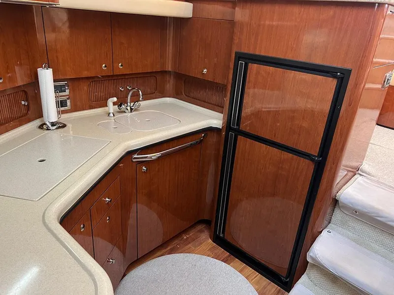 Slide: The Image of 2003 Sea Ray 390 Motor Yacht kitchen with wood cabinetry and compact appliances. - 42