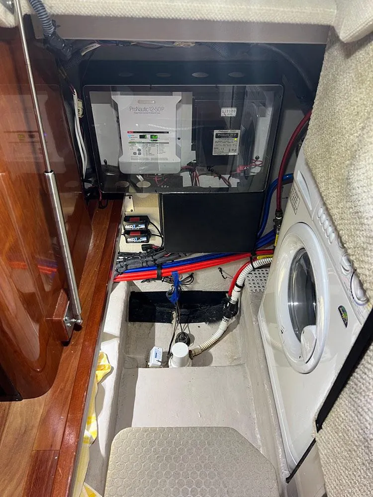 Slide: The Image of Laundry area in 2003 Sea Ray 390 Motor Yacht with washer and electrical panel. - 43