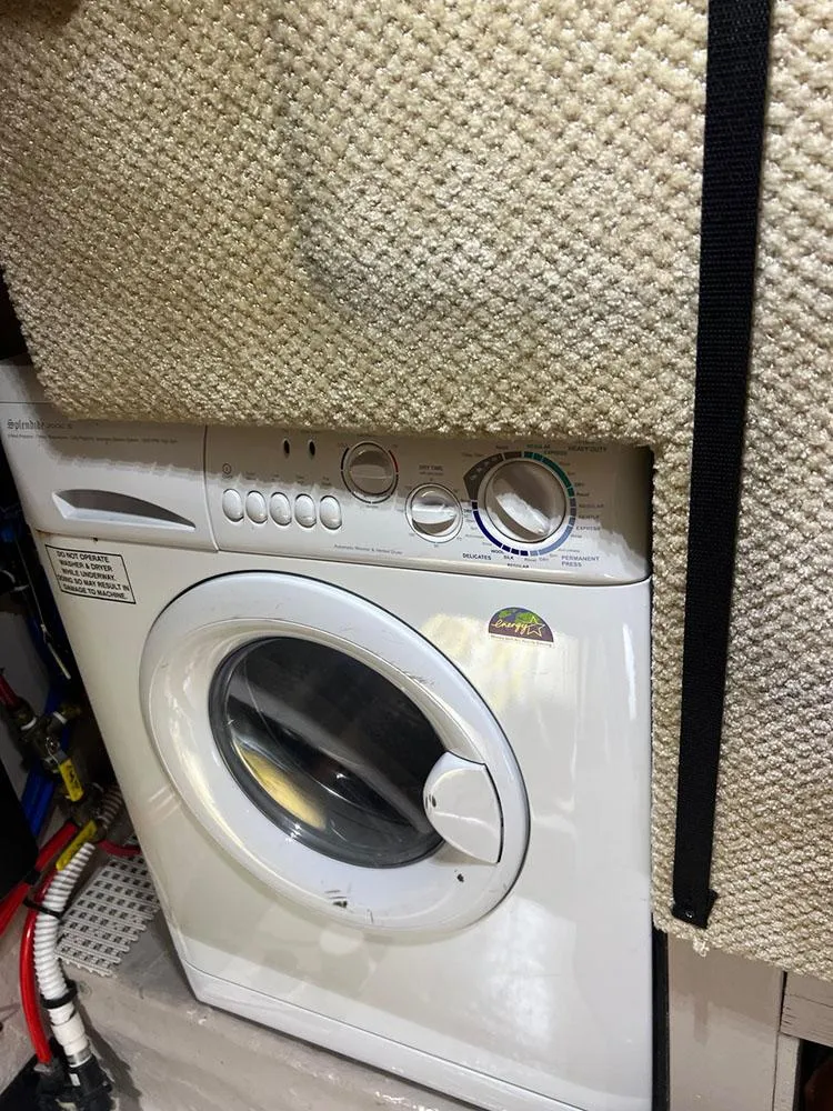 Slide: The Image of Washing machine inside a 2003 Sea Ray 390 Motor Yacht, partially covered by a textured mat. - 44