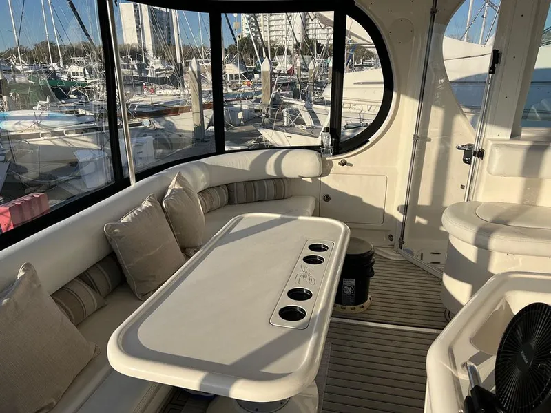 Slide: The Image of Interior of 2003 Sea Ray 390 Motor Yacht with seating and table, docked at marina. - 47
