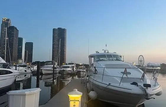 Slide: The Image of 2003 Sea Ray 390 Motor Yacht docked at marina with city skyline backdrop. - 6