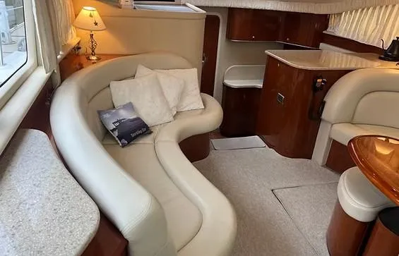 Slide: The Image of Luxurious interior of 2003 Sea Ray 390 Motor Yacht with elegant seating and wooden finishes. - 7