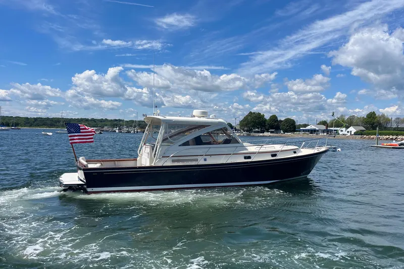 Slide: The Image of 2002 Little Harbor WhisperJet boat cruising on a sunny day with an American flag. - 11