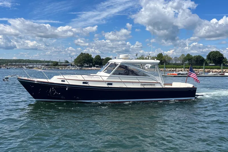 Slide: The Image of 2002 Little Harbor WhisperJet boat cruising on a sunny day with American flag. - 12