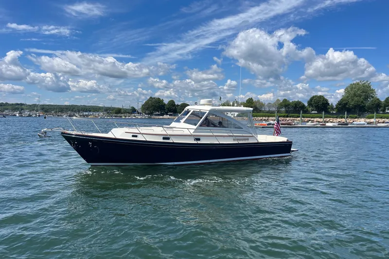 Slide: The Image of 2002 Little Harbor WhisperJet boat on calm water under a blue sky. - 13