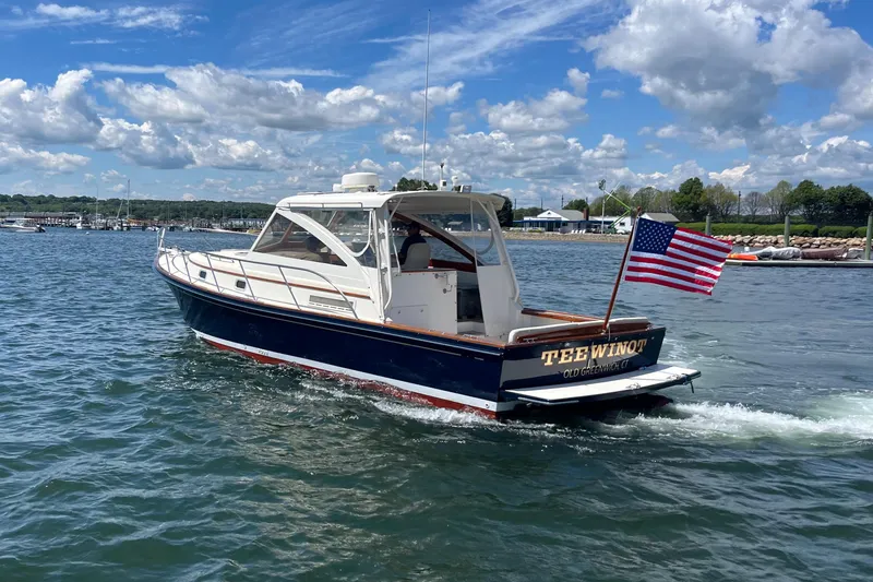 Slide: The Image of 2002 Little Harbor WhisperJet boat cruising on a sunny day with American flag. - 15