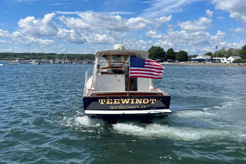 Slide: The Image of 2002 Little Harbor WhisperJet boat with American flag on water, labeled "TEEWINOT," Old Greenwich, CT. - 17