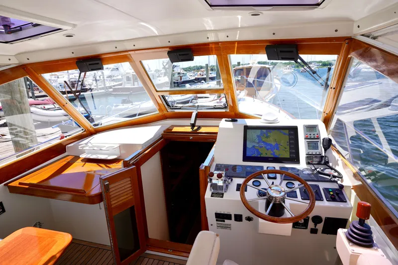 Slide: The Image of 2002 Little Harbor WhisperJet yacht cockpit with navigation equipment and wooden accents. - 2