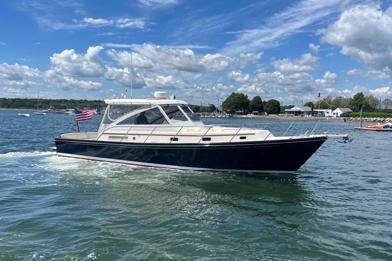 Slide: The Image of 2002 Little Harbor WhisperJet cruising on a sunny day with an American flag. - 20