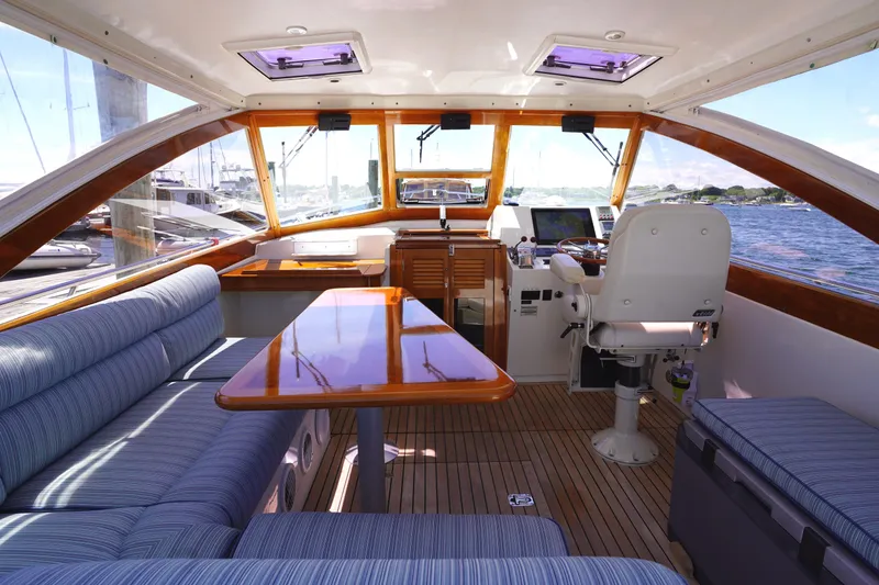 Slide: The Image of Interior of 2002 Little Harbor WhisperJet boat with seating, table, and helm station. - 21