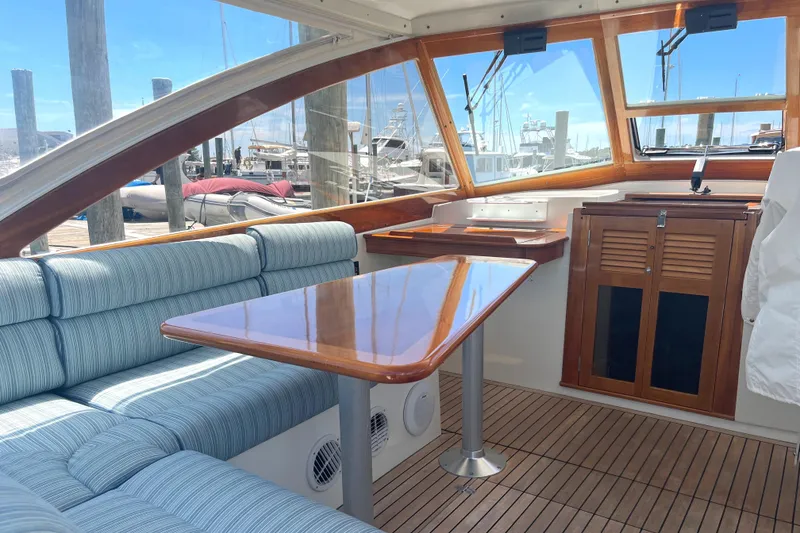 Slide: The Image of Interior of 2002 Little Harbor WhisperJet with wood accents and blue seating. - 27