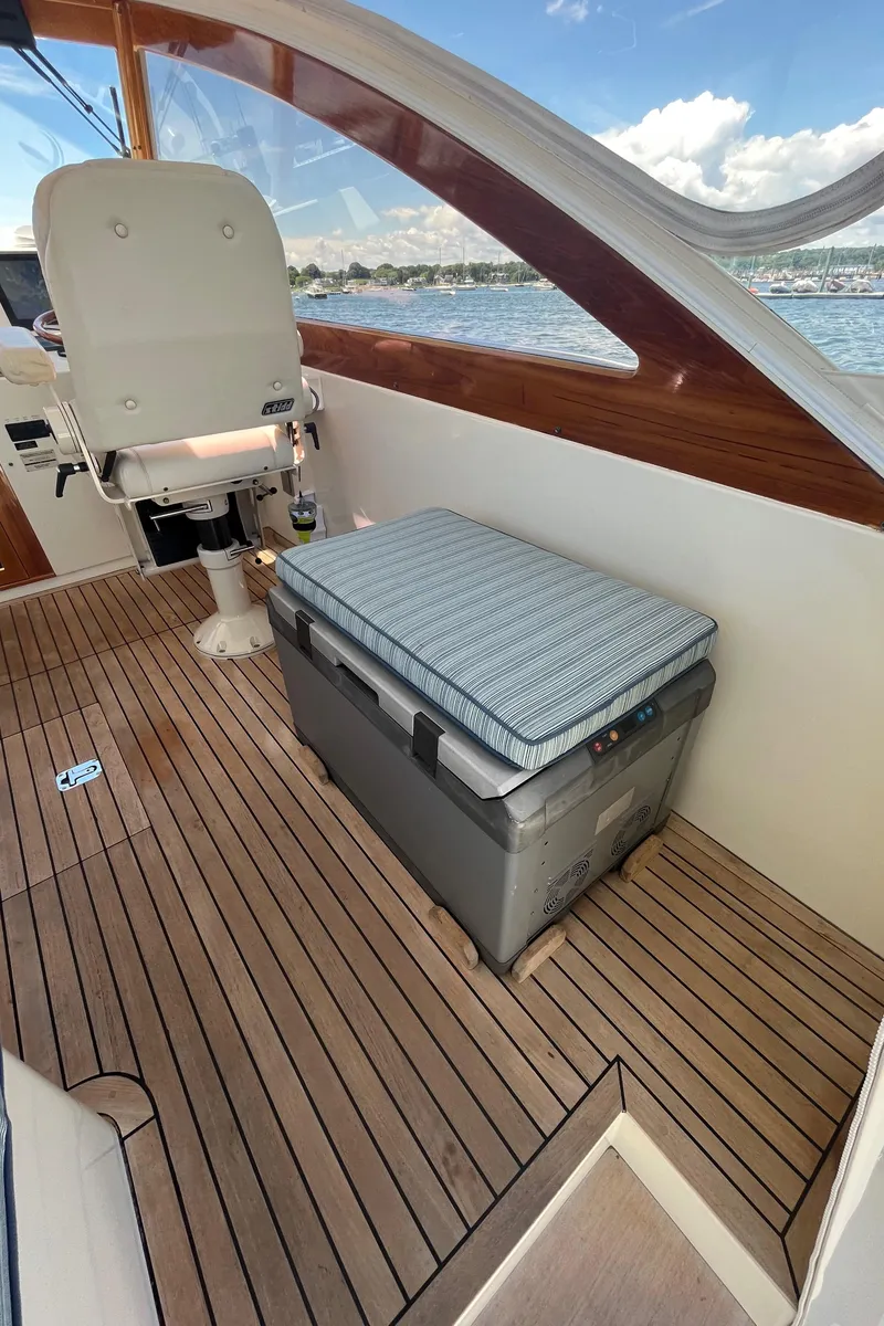 Slide: The Image of 2002 Little Harbor WhisperJet interior with wooden deck and cushioned seating. - 29