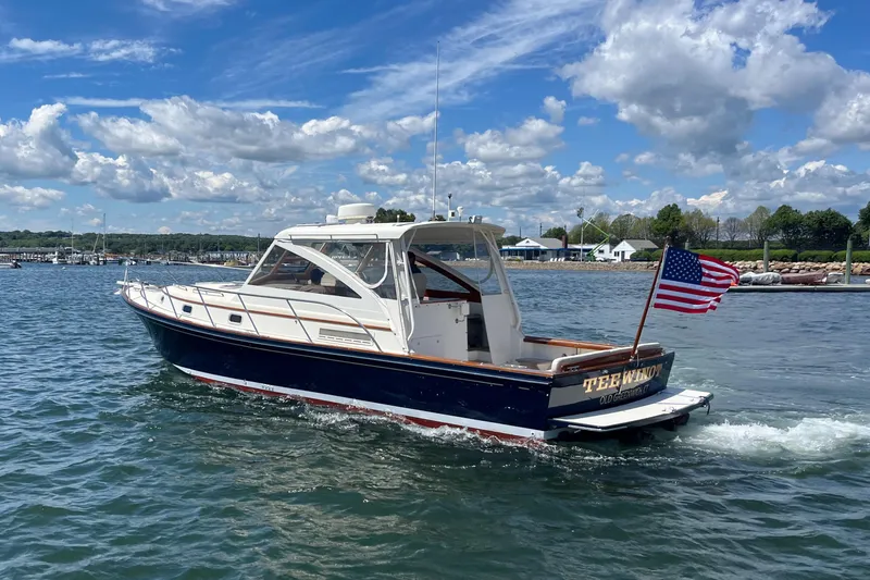 Slide: The Image of 2002 Little Harbor WhisperJet boat cruising on a sunny day with American flag. - 3