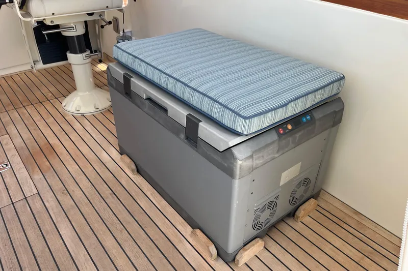 Slide: The Image of Cushioned cooler on 2002 Little Harbor WhisperJet boat deck with wooden flooring. - 30