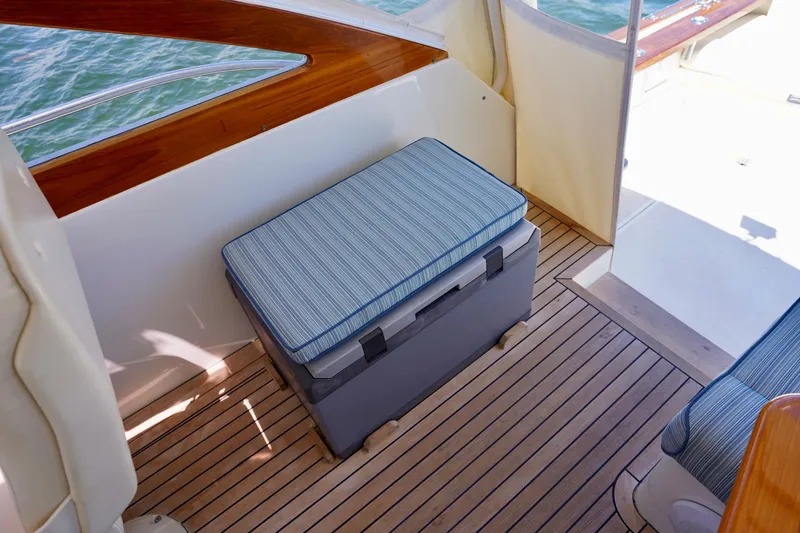 Slide: The Image of 2002 Little Harbor WhisperJet boat interior with cushioned seating and wooden flooring. - 31