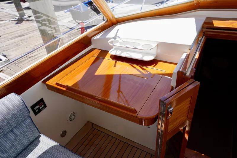 Slide: The Image of 2002 Little Harbor WhisperJet interior with polished wood table and seating. - 32