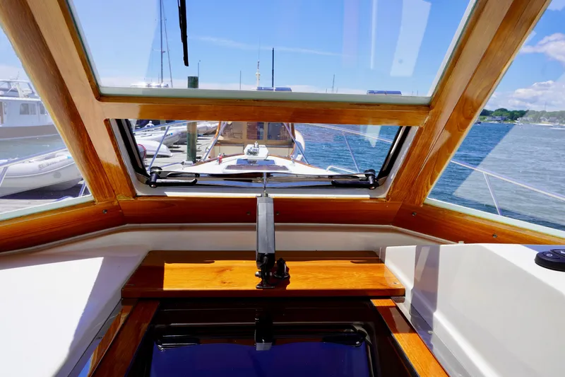 Slide: The Image of Interior view of 2002 Little Harbor WhisperJet boat with wooden accents and ocean backdrop. - 35