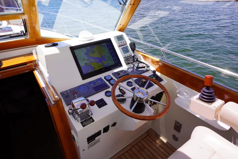 Slide: The Image of Helm of 2002 Little Harbor WhisperJet boat with navigation equipment and wooden steering wheel. - 39
