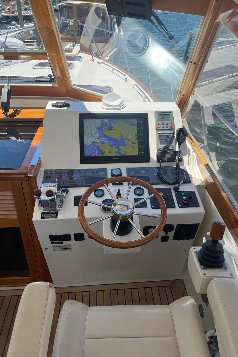 Slide: The Image of 2002 Little Harbor WhisperJet helm with navigation display and wooden steering wheel. - 40