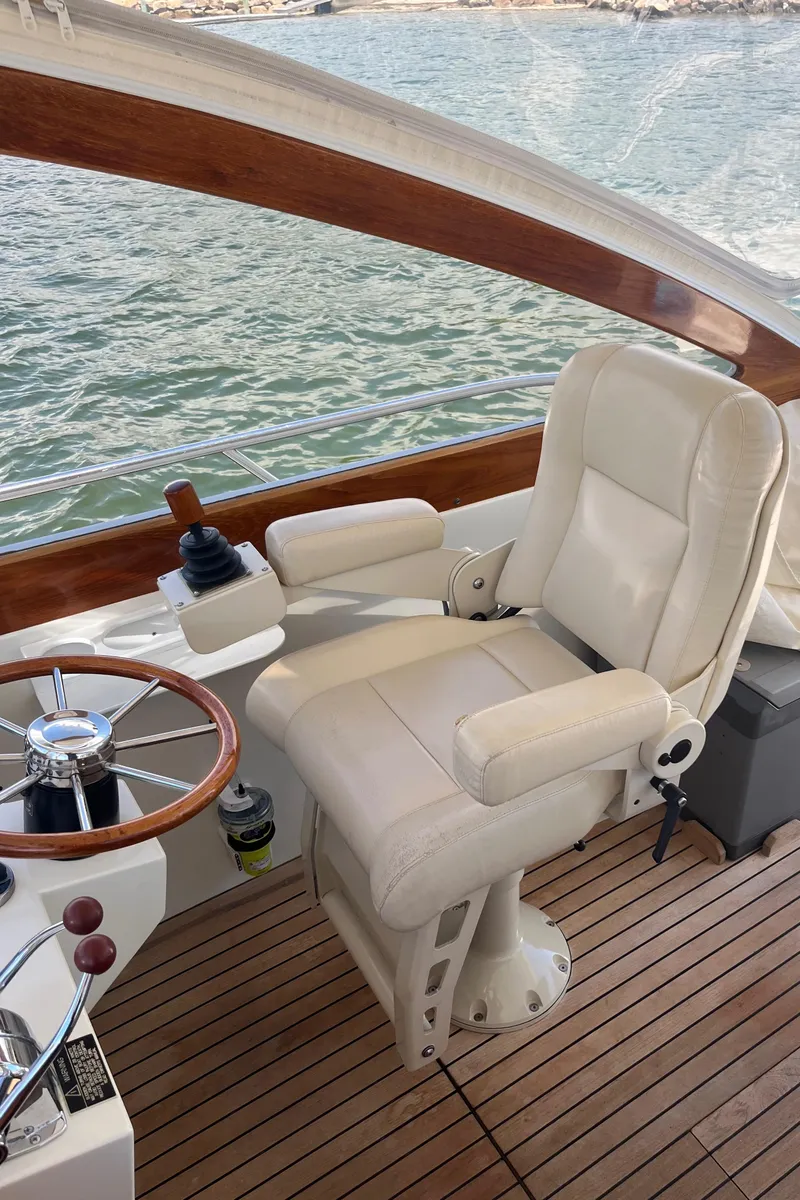 Slide: The Image of Captain's chair on 2002 Little Harbor WhisperJet boat, with wooden accents and water view. - 41