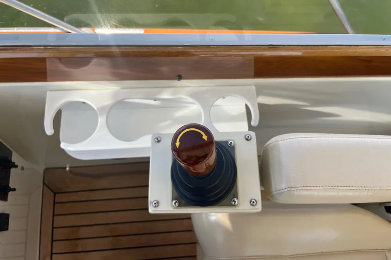 Slide: The Image of 2002 Little Harbor WhisperJet control panel with joystick and cup holders. - 43