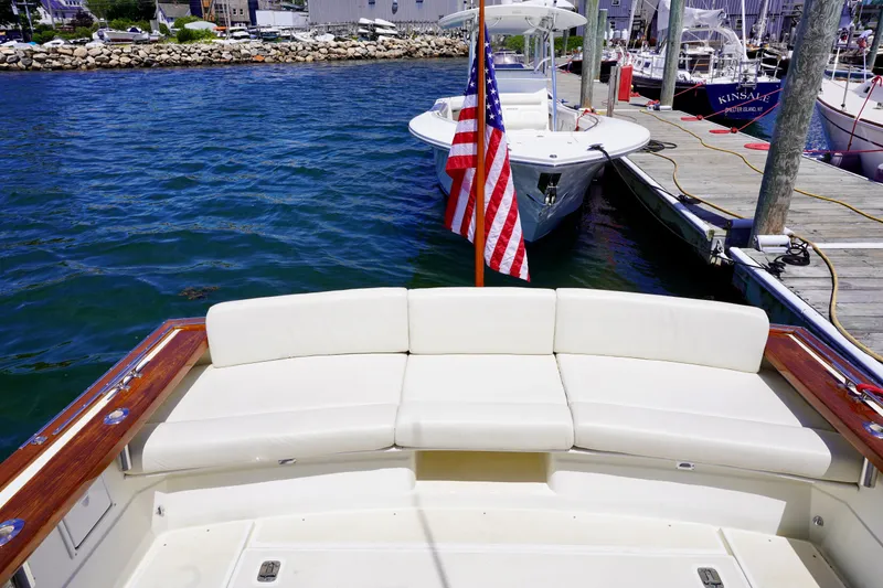 Slide: The Image of 2002 Little Harbor WhisperJet boat with American flag, docked at marina. - 5
