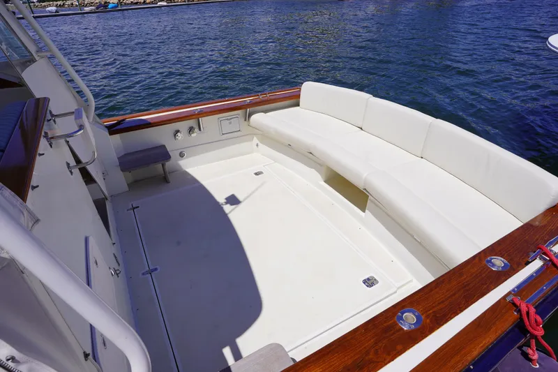Slide: The Image of 2002 Little Harbor WhisperJet boat with spacious seating area by the water. - 6