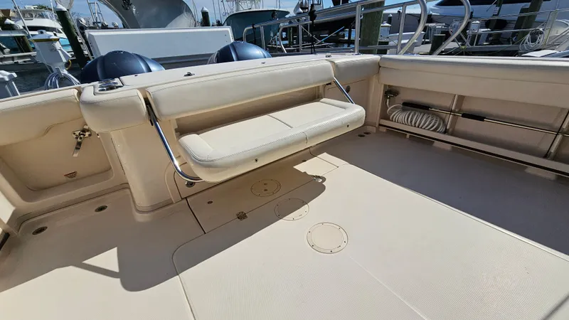 Slide: The Image of 2016 Grady-White Express 330 boat interior with foldable seating and spacious deck area. - 16